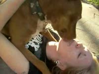 Blonde kissing her dog mouth to mouth
